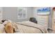 Comfortable bedroom with mounted TV, side chair, and decorative pillows at 7108 Harle Ave, North Port, FL 34291