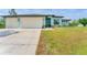 A beautiful house with a three car garage and a well maintained front lawn at 7108 Harle Ave, North Port, FL 34291