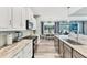 Bright kitchen with stainless steel appliances, stone countertops, and seamless access to the dining area at 7108 Harle Ave, North Port, FL 34291