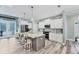 Spacious kitchen featuring white cabinets, stainless steel appliances and a large center island at 7108 Harle Ave, North Port, FL 34291