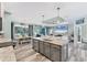 Open kitchen and dining area featuring an island with stainless steel appliances at 7108 Harle Ave, North Port, FL 34291