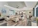 Open-concept living room and kitchen with a neutral color palette and lots of natural light at 7108 Harle Ave, North Port, FL 34291