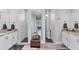 Symmetrical main bathroom featuring dual vanities, mirrored niche, and separate glass-enclosed shower stalls at 7108 Harle Ave, North Port, FL 34291