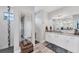 Modern main bathroom featuring dual vanities, quartz countertops, and a glass-enclosed shower stall at 7108 Harle Ave, North Port, FL 34291