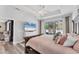 Spacious main bedroom with a ceiling fan, TV, and sliding glass doors leading to a lanai at 7108 Harle Ave, North Port, FL 34291