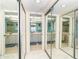 Hallway view into mirrored bathrooms with vanities and well-lit mirrors, creating a clean, functional space at 7466 Palm Island Dr # 2913, Placida, FL 33946