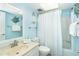 Bathroom featuring blue walls, a white vanity, and a shower with a decorative shower curtain at 7466 Palm Island Dr # 2913, Placida, FL 33946