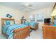 Cozy bedroom with two twin beds, ceiling fan, and decorative crab accents on the wall at 7466 Palm Island Dr # 2913, Placida, FL 33946