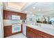 Well-equipped kitchen with stainless steel appliances, wood cabinets, and white countertops at 7466 Palm Island Dr # 2913, Placida, FL 33946