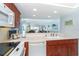 Bright kitchen featuring a cooktop, white appliances, and a passthrough to the living area with a view at 7466 Palm Island Dr # 2913, Placida, FL 33946