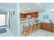 Stylish kitchenette with bar seating, wood cabinets, and a view into the adjacent room at 7466 Palm Island Dr # 2913, Placida, FL 33946