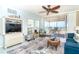 Cozy living room with a plush blue sofa, lanai access, and scenic ocean views for relaxed coastal living at 7466 Palm Island Dr # 2913, Placida, FL 33946