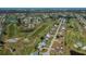 Aerial view of the community, golf course, lakes, and the home marked with an arrow at 81 Oakland Hills Pl, Rotonda West, FL 33947