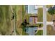 Birds eye view of the home with a brown roof, golf course behind, and close to a pool at 81 Oakland Hills Pl, Rotonda West, FL 33947
