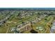 Overhead view of a neighborhood on a golf course and the location of the listing marked with an arrow at 81 Oakland Hills Pl, Rotonda West, FL 33947
