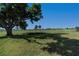 Expansive backyard view with lush grass and shady trees overlooking the golf course at 81 Oakland Hills Pl, Rotonda West, FL 33947