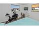 Cozy bedroom with exercise equipment, complemented by a desk and natural light at 81 Oakland Hills Pl, Rotonda West, FL 33947