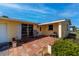 Welcoming yellow home with a lovely tile front porch, white trim and a rocking chair at 81 Oakland Hills Pl, Rotonda West, FL 33947