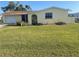 Charming one-story yellow home with a garage and well-maintained front yard at 81 Oakland Hills Pl, Rotonda West, FL 33947