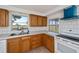 Bright kitchen boasts wood cabinets, white countertops, and an open view to the outdoors at 81 Oakland Hills Pl, Rotonda West, FL 33947