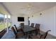 Enclosed lanai features a ceiling fan, outdoor dining set and access to the backyard at 81 Oakland Hills Pl, Rotonda West, FL 33947
