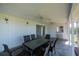 Lanai with outdoor seating and a pass-through window to the kitchen at 81 Oakland Hills Pl, Rotonda West, FL 33947