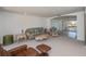 Inviting living room featuring comfortable seating and tiled access to the lanai at 81 Oakland Hills Pl, Rotonda West, FL 33947