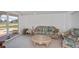 Relaxing living room features wicker furniture and bright natural light at 81 Oakland Hills Pl, Rotonda West, FL 33947