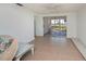 Spacious living area with tile flooring and access to a screened lanai at 81 Oakland Hills Pl, Rotonda West, FL 33947