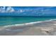 A peaceful beach with gentle waves lapping the shore and clear, turquoise water at 8714 King St, Placida, FL 33946