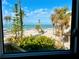Stunning beach view with palm trees, turquoise water, and clear blue sky at 8714 King St, Placida, FL 33946
