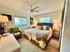 Tranquil bedroom with water view, wicker accents, and neutral tones at 8714 King St, Placida, FL 33946