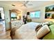 Serene bedroom with bright natural light, large mirror, and coastal inspired decor at 8714 King St, Placida, FL 33946