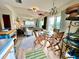 Bright dining area with round glass table, wood chairs, and access to outdoor views from sliding glass doors at 8714 King St, Placida, FL 33946