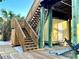 Wooden stairs and boardwalk leading to the elevated beach house, providing easy access and showcasing coastal architecture at 8714 King St, Placida, FL 33946