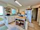 Well-lit kitchen with a center island, white appliances, and easy access to the outdoor deck at 8714 King St, Placida, FL 33946