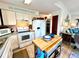 Efficient kitchen featuring white cabinets, modern appliances, and a functional center island for meal preparation at 8714 King St, Placida, FL 33946