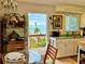 Kitchen view with ocean views from dining table, wooden deck access, and bright, airy interiors at 8714 King St, Placida, FL 33946