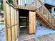 Rustic outdoor shower with wood paneling and a bench, perfect for rinsing off after a day at the beach at 8714 King St, Placida, FL 33946