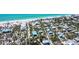 Aerial view of a community with beautiful blue water, beachfront homes, and the home of interest highlighted in yellow at 8812 Grand Ave, Placida, FL 33946
