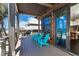 Charming porch boasts seating and doors that lead to an airy living space, capturing beautiful outdoor scenery at 8812 Grand Ave, Placida, FL 33946