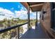 Balcony view featuring wood floors and cable railing, overlooking tropical landscaping and neighboring homes at 8812 Grand Ave, Placida, FL 33946