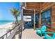 Relaxing balcony with Adirondack chairs and clear ocean views by the windows and glass doors at 8812 Grand Ave, Placida, FL 33946