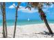 Beach view featuring clear turquoise water, white sand beach, and a sailboat in the distance at 8812 Grand Ave, Placida, FL 33946