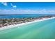 Aerial view of homes on the beach with beautiful blue water, and the home of interest highlighted in yellow at 8812 Grand Ave, Placida, FL 33946