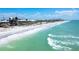 Coastal homes sit along a pristine beachfront with turquoise water and clear skies in this picturesque waterfront community at 8812 Grand Ave, Placida, FL 33946