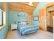 Cozy bedroom with wood ceiling, coastal decor, and a sliding barn door at 8812 Grand Ave, Placida, FL 33946