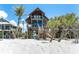 Stunning elevated beach house with rustic wood exterior, multiple decks, and easy beach access via wooden stairs at 8812 Grand Ave, Placida, FL 33946