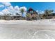 Coastal beach homes line the shore with beautiful wood exteriors and tropical landscaping at 8812 Grand Ave, Placida, FL 33946