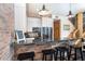 A kitchen area with white cabinets, stainless steel appliances, black countertop, and a breakfast bar with seating at 8812 Grand Ave, Placida, FL 33946